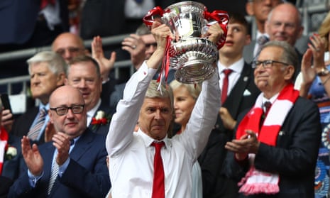 Arsène Wenger, the Arsenal manager, shows his pride when lifting the FA Cup trophy