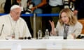 Pope Francis and Italian Prime Minister Giorgia Meloni talk while sat at a table