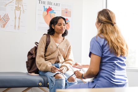 Teenage girl listens intently to a female doctor