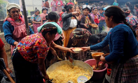Villagers prepare food at the wake in Gómez’s home village of San Juan Ostuncalco in western Guatemala.