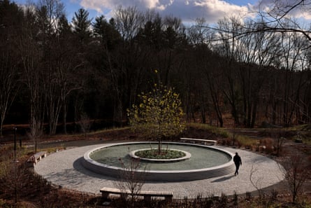 A visitor walks around the pool at the Sandy Hook Permanent Memorial.