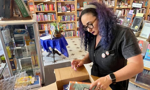 Woman packs books into a box