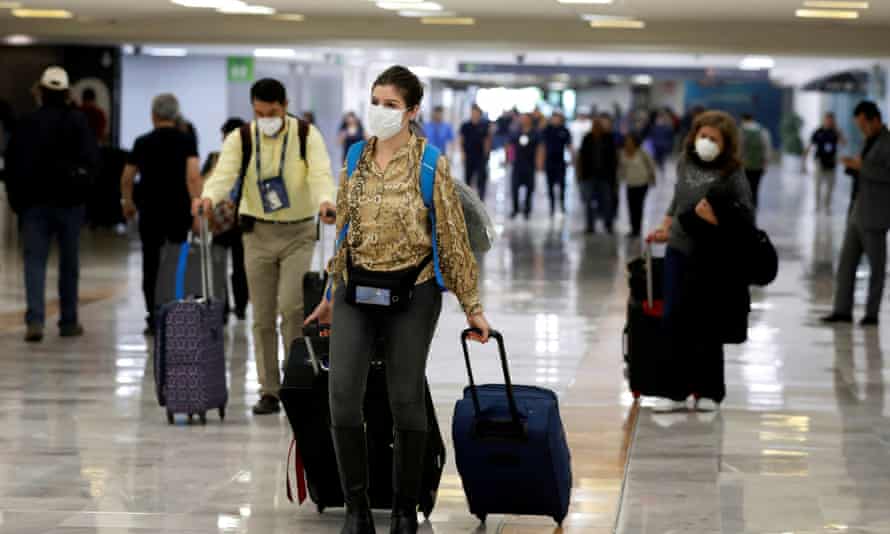 FILE PHOTO: People wear protective face masks at Benito Juarez International Airport in Mexico City, Mexico.