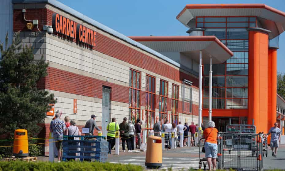 People queue outside a B&amp;Q in Warrington, Cheshire.