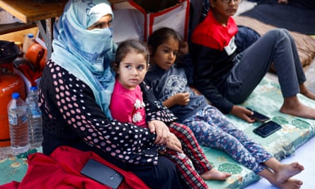 A Palestinian women with her children in a shelter