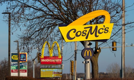 The sign for CosMc’s on the side of the road, beside other mall signs.