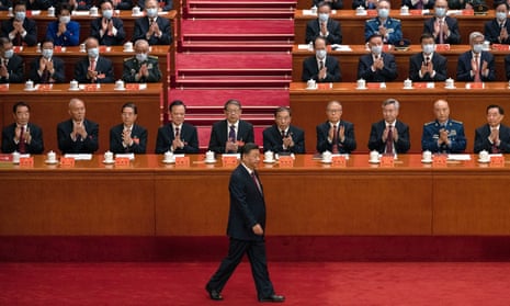 Chinese President Xi Jinping is applauded by senior members of the government and delegates as he walks to the podium before his speech during the Opening Ceremony of the 20th National Congress of the Communist Party of China