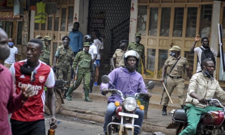 Security forces patrol a street in Kampala after protests over the arrest of Bobi Wine.