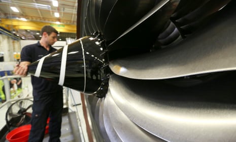 An employee checks the nose cone of an aircraft engine on the production line at the Rolls-Royce factory in Derby