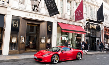 A red Ferrari parked on New Bond Street in London.