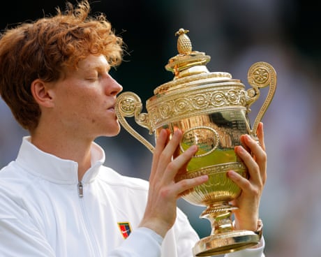 Jannik Sinner kisses the Wimbledon trophy on Centre Court