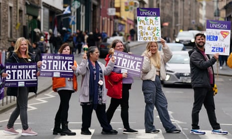 School support workers from the Unison union on a picket line at Royal Mile primary school in Edinburgh earlier today.
