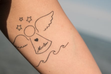 An limb showing a tattoo pinch an angel that has nan sanction Marlow connected it beneath a heart