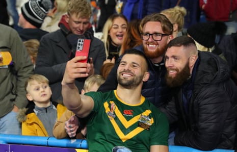 Josh Mansour of Lebanon takes a selfie with fans while wearing an Australian shirt.