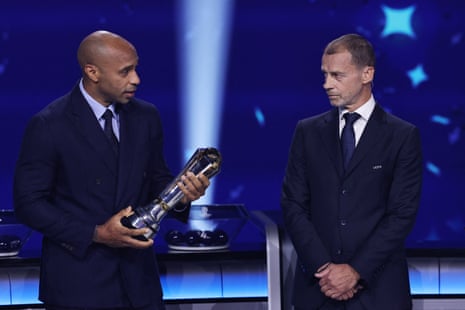 Former footballer Thierry Henry receives the UEFA president's award from UEFA president Aleksander Ceferin ahead of the league phase draw.