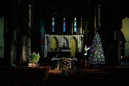 Woman dressing a Christmas tree in St Anne’s church.