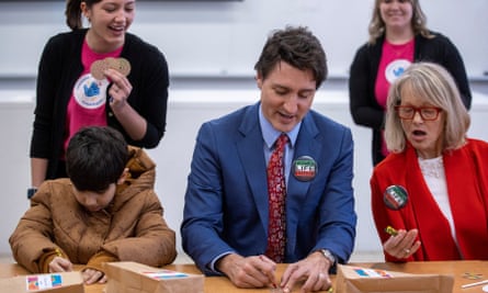 Justin Trudeau sits with children while participating in science based crafts at the Persian community’s Nowruz New Year event in Aurora, Ontario, on Saturday.