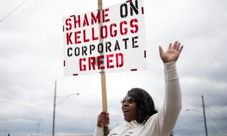 Keisha Richardson holds sign that says 'shame on kelloggs corporate greed'