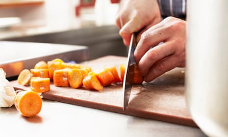 A chef chopping carrots
