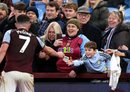 A young Aston Villa fan receives the captain's armband from John McGinn after the team's victory against Wolves on 30 November.