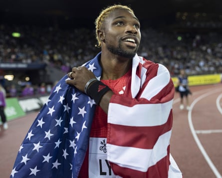 Noah Lyles drapes the United States flag over his shoulder after winning the men’s 200m competition during the Diamond League final