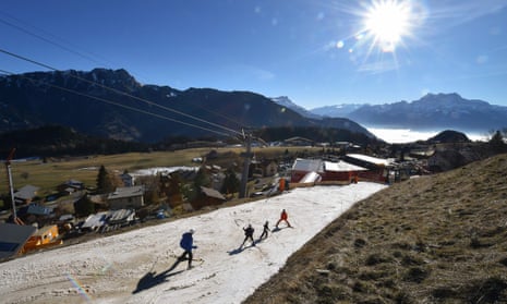 Tourists ski on a thin layer of snow in Leysin, Switzerland during the country’s warmest December on record.
