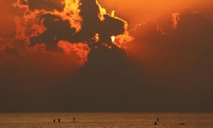 Sun through clouds at beach