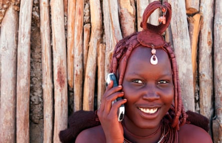 A Himba tribeswoman makes a call from a remote region in Namibia.