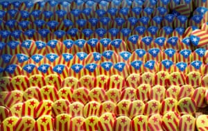 Pins with the colours of the Catalan flag are seen at a stand near the regional parliament in Barcelona, Spain