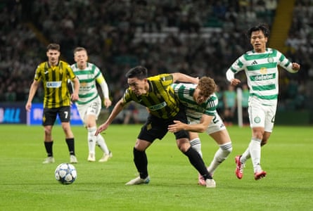 Yerkin Tapalov of Kairat Almaty holds off Arne Engels of Celtic