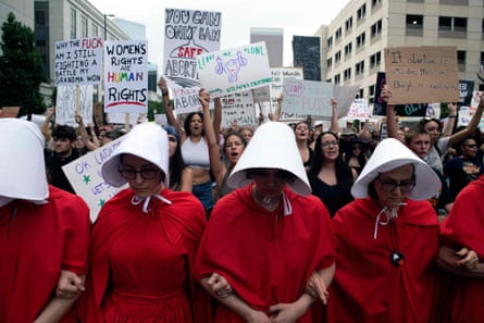 Abortion rights activists, dressed in an outfit from the Handmaid’s Tale