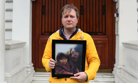 Richard Ratcliffe outside the Iranian embassy in London with a picture of his wife and daughter