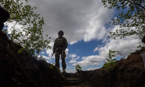 A Ukrainian serviceman stands near an artillery position on the outskirts of Chasiv Yar.