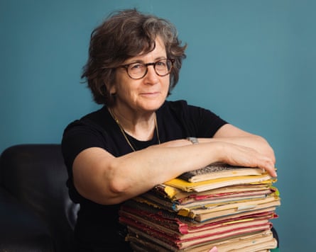Betsy Lerner leans on a stack of papers