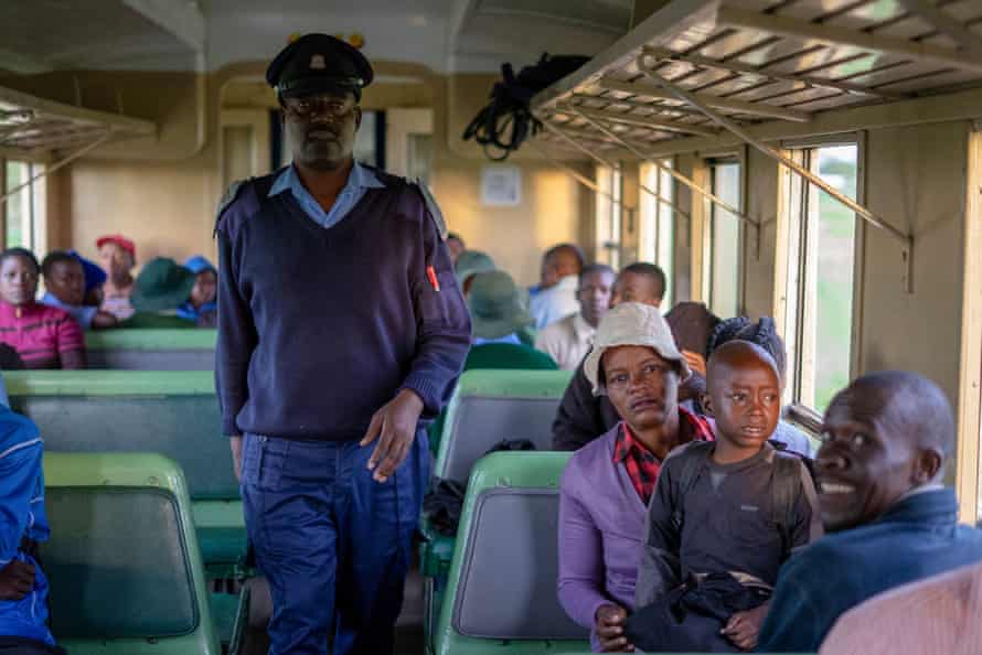 A Zimbabwe National Railways security officer conducts a routine ticket check.