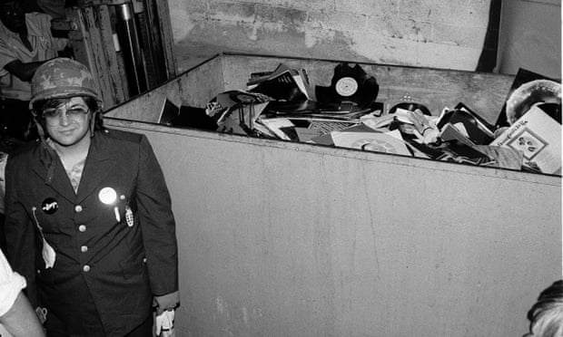 Steve Dahl beside the dumpster full of records collected for Disco Demolition Night.