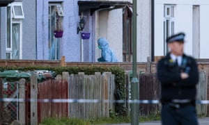 A forensic investigator enters a house in Sunbury-on-Thames raided by police on Saturday in the hunt for the Parsons Green bomber.