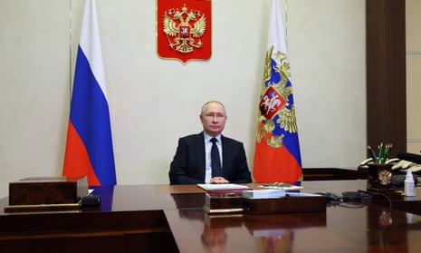 Vladimir Putin chairs a security council meeting via a video link at the Novo-Ogaryovo state residence, outside Moscow