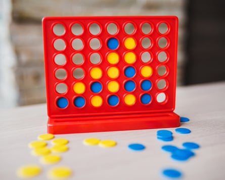 The Connect 4 game, with pieces strewn beside it