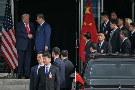 Donald Trump and Xi Jinping shake hands as they leave after their talks at the Gimhae airbase in South Korea after talks on the sidelines of Apec