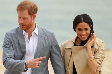 Prince Harry wears a Oura health fitness tracker ring while walking on a beach in Australia with his wife, Meghan, in 2018