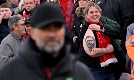 A Liverpool fan shows off her tattoo of Jurgen Klopp