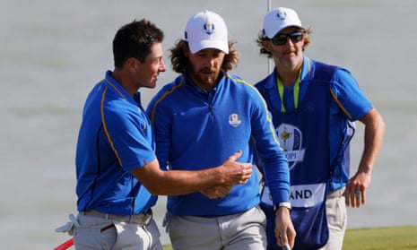 Tommy Fleetwood and Viktor Hovland react on the 8th green after winning the hole.