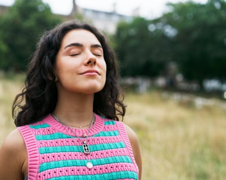 Woman pinch eyes closed, relaxed, outdoors