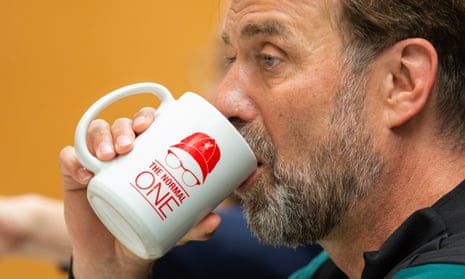 Liverpool's manager Jürgen Klopp drinks from a mug saying 'The Normal One' during a press conference earlier this week.