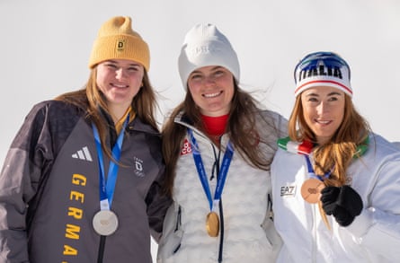 Breezy Johnson poses with silver medalist Emma Aicher (left) of Germany and bronze medalist Sofia Goggia of Italy.