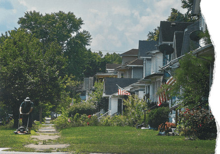 A resident mows the lawn in front of his home along McKinley Street in Middletown, Ohio.