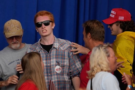 A Trump supporter in a MAGA cap and a Gasdsen flag helped force an anti-ICE protester out of a Donald Trump rally in Dalton, Georgia on Friday.