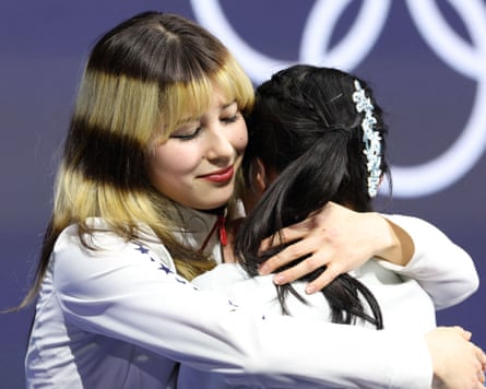 Alysa Liu embraces Ami Nakai after the pair won ice skating gold and bronze respectively.