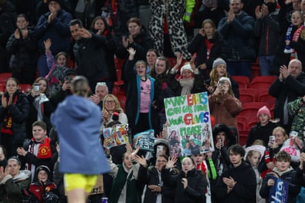 Fans cheer former Manchester United player, PSG's keeper Mary Earps, as she walks off the pitch at the end of the Women's Champions League football match at Manchester United .